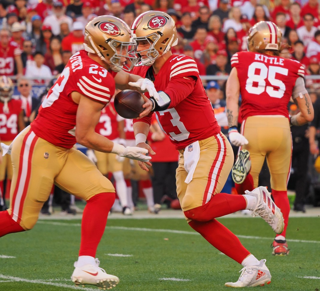 San Francisco 49ers quarterback Brock Purdy (13) hands the ball off to running back Christian McCaffrey (23) NFC West