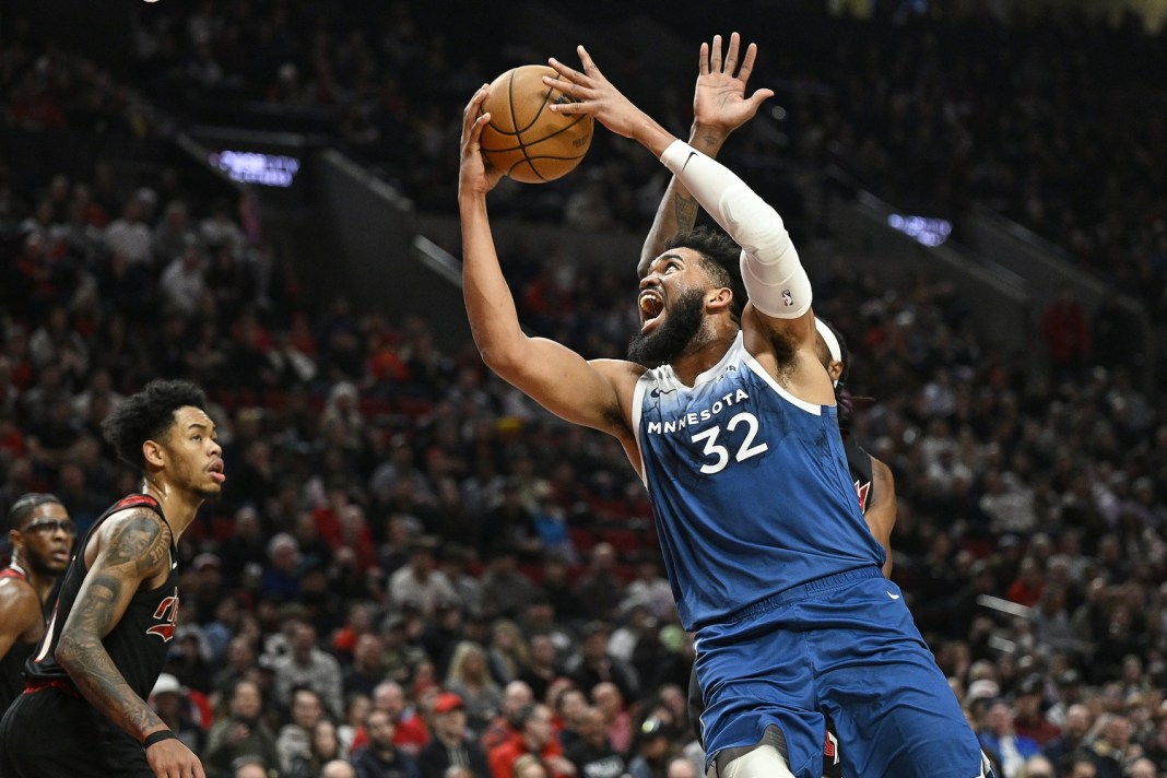 Minnesota Timberwolves center Karl-Anthony Towns (32) drives to the basket during the first half against Portland Trail Blazers forward Jerami Grant (9) at Moda Center