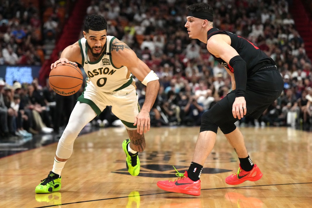 NBA: Boston Celtics at Miami Heat Boston Celtics forward Jayson Tatum drives to the basket as Miami Heat guard Tyler Herro defends during the first half at Kaseya Center.