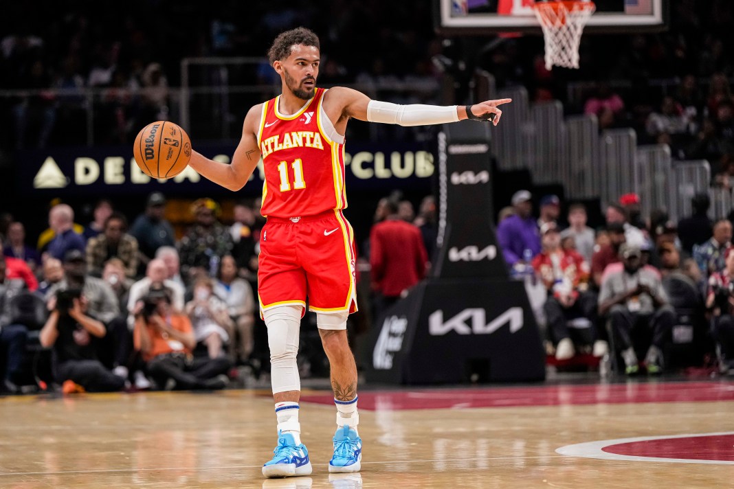 Hawks star Trae Young directs traffic in a meeting with the Hornets during the 2023-24 NBA season.