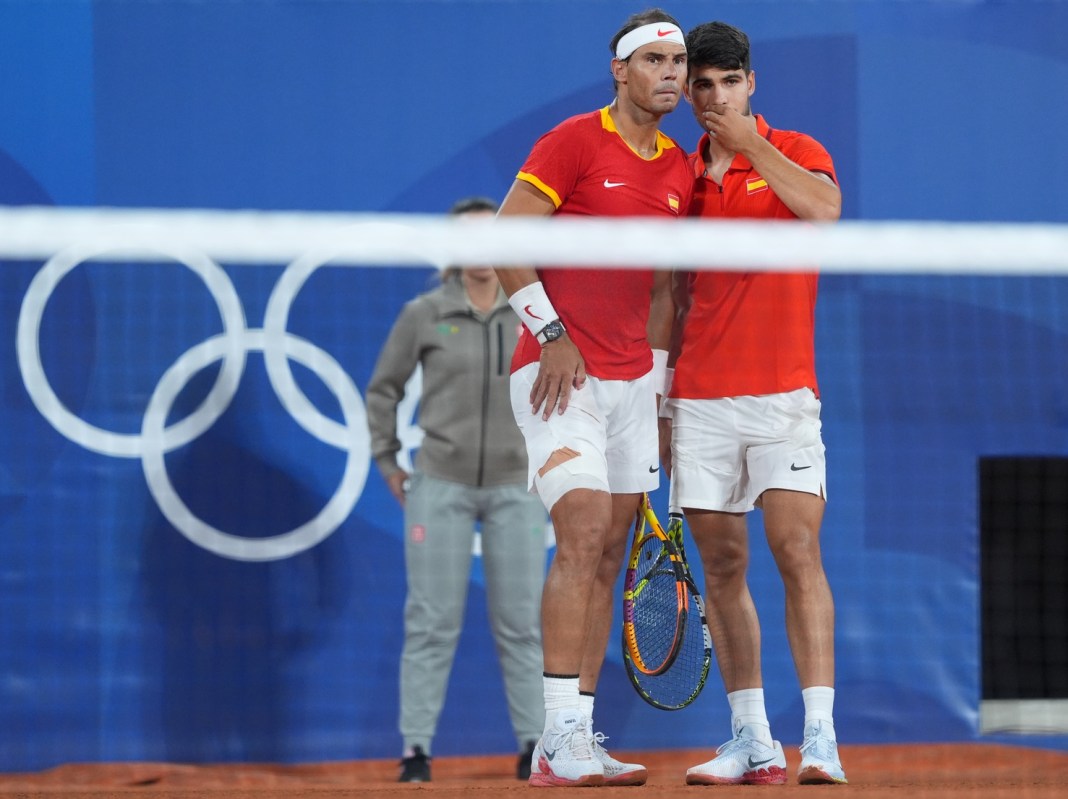 Olympics: Tennis Spain's Rafael Nadal and Carlos Alcaraz strategize in their doubles match at the 2024 Paris Olympics.
