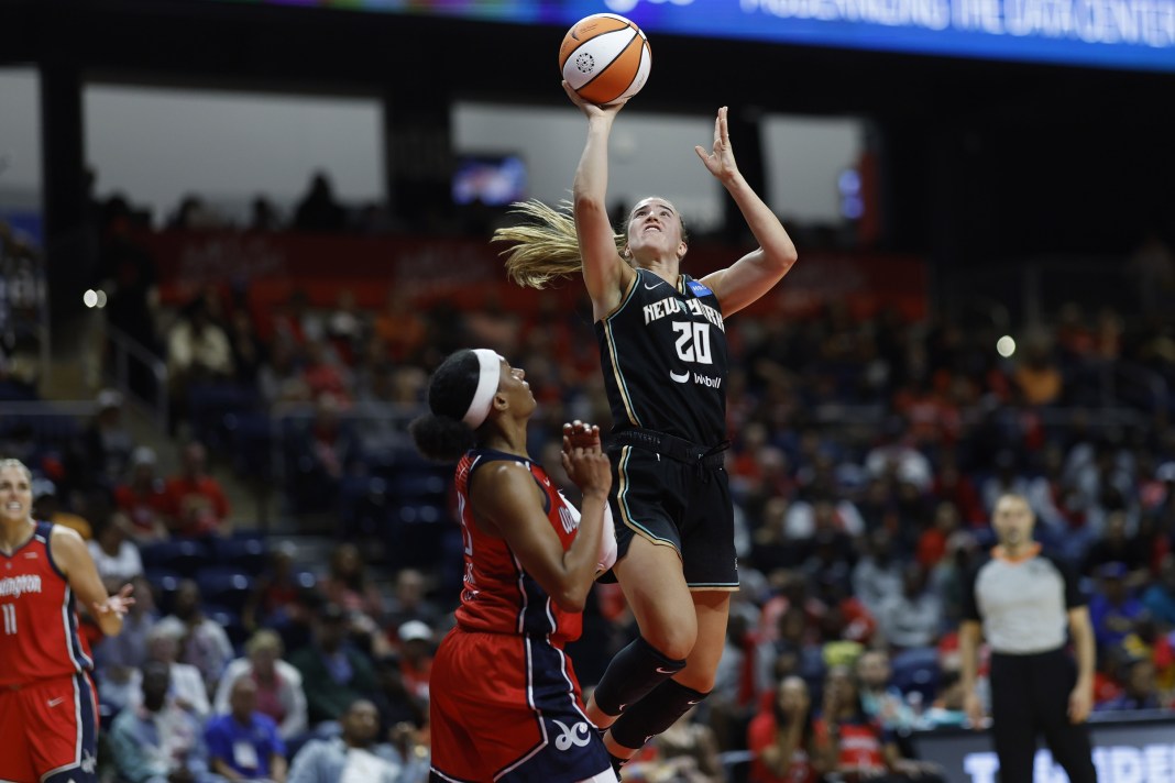New York Liberty guard Sabrina Ionescu (20) shoots the ball as Washington Mystics guard Brittney Sykes (15) defends in the second quarter of the game at Entertainment & Sports Arena in Washington, D.C., on May 19, 2023.