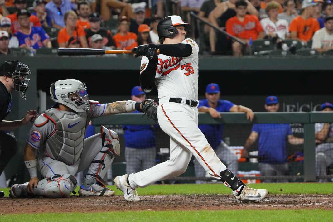 Baltimore Orioles catcher Adley Rutschman (35) hits an RBI single during the eighth inning of the game against the New York Mets at Oriole Park at Camden Yards on August 5, 2023.