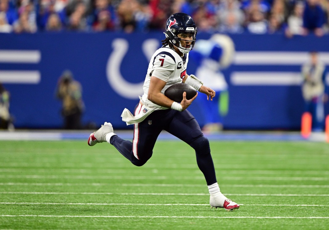 Houston Texans quarterback C.J. Stroud (7) runs the ball against the Indianapolis Colts during the second half at Lucas Oil Stadium on January 6, 2024.