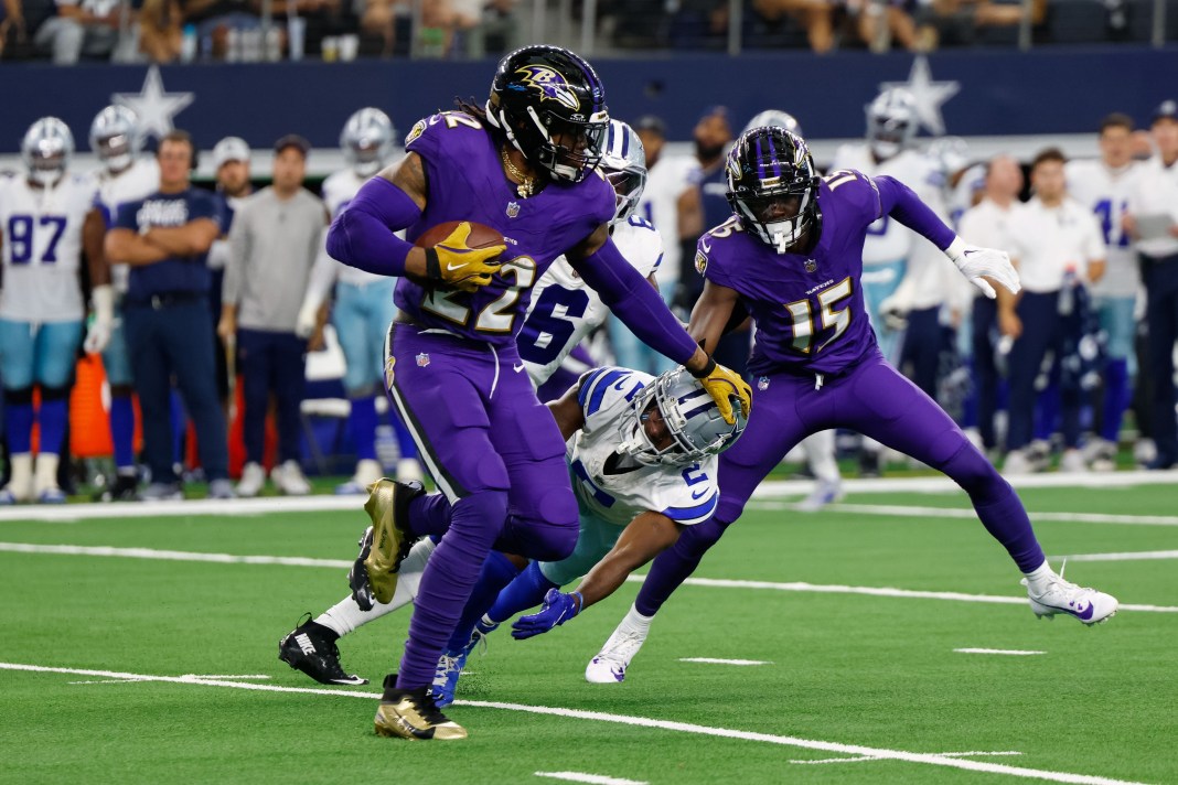 Baltimore Ravens running back Derrick Henry (22) stiff arms Dallas Cowboys cornerback Jourdan Lewis (2) during the third quarter at AT&T Stadium on September 22, 2024.