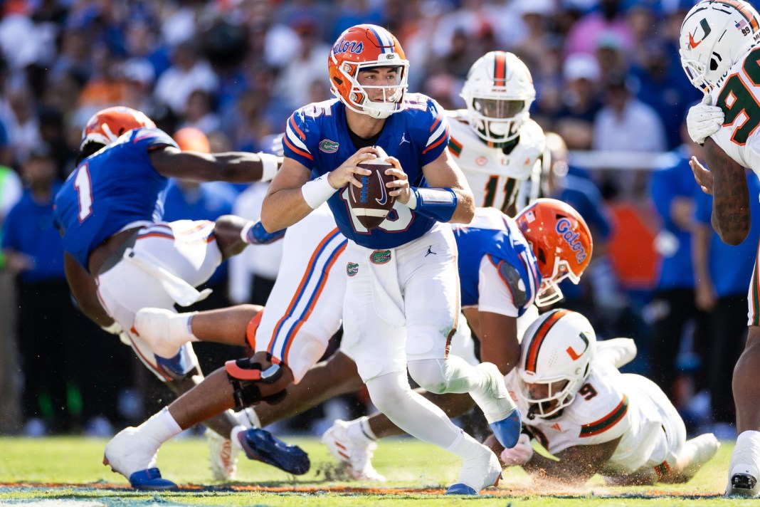 Florida Gators quarterback Graham Mertz (15) runs with the ball out of the pocket against the Miami Hurricanes during the first half at Ben Hill Griffin Stadium on August 31, 2024.