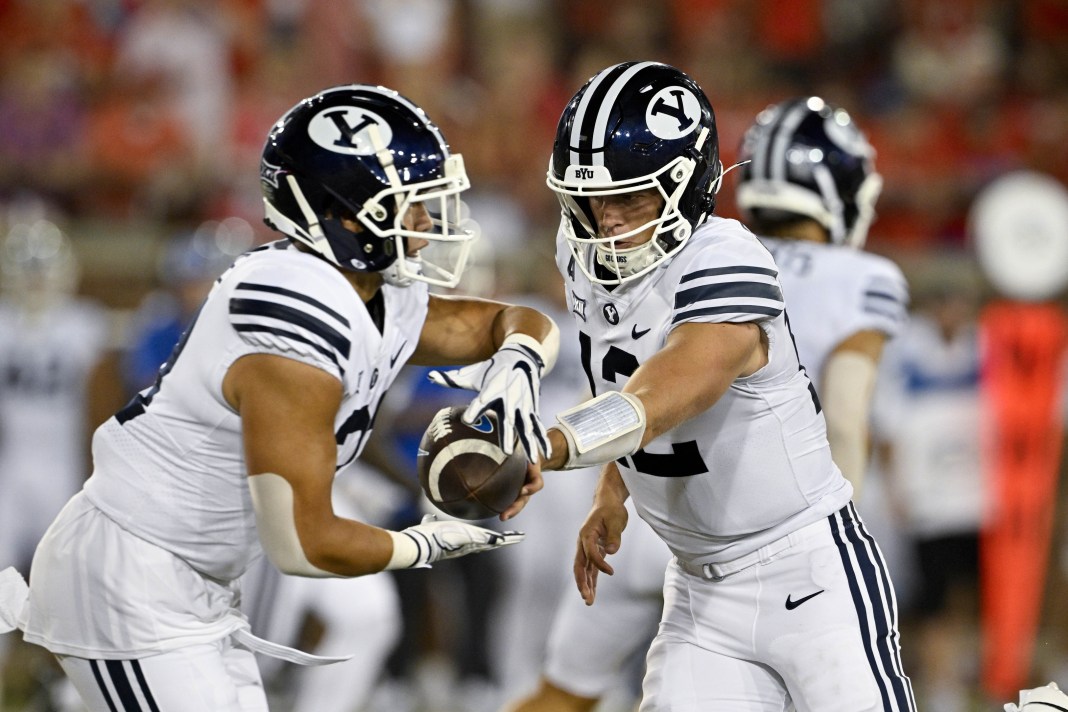 Brigham Young Cougars running back LJ Martin (27) and quarterback Jake Retzlaff (12) in action during the game against the Southern Methodist Mustangs at Gerald J. Ford Stadium on September 6, 2024.