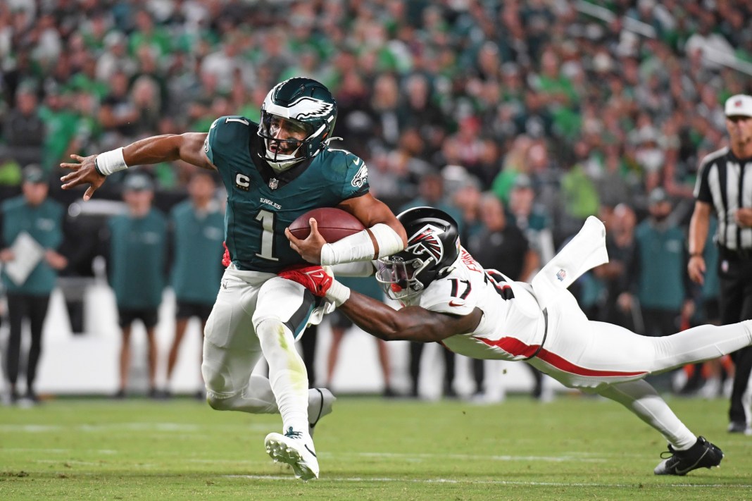 Philadelphia Eagles quarterback Jalen Hurts (1) is tackled by Atlanta Falcons linebacker Arnold Ebiketie (17) at Lincoln Financial Field on September 16, 2024.