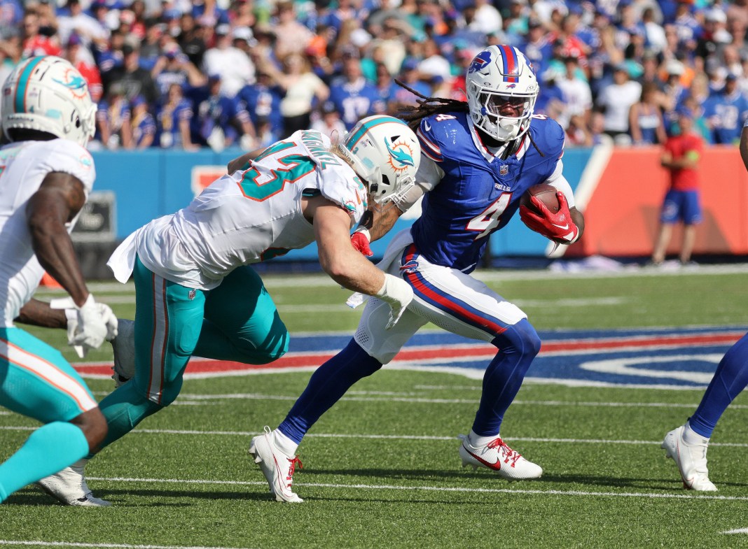 Syndication: Democrat and Chronicle Bills running back James Cook looks for room to run against the Dolphins during a game at Hard Rock Stadium.