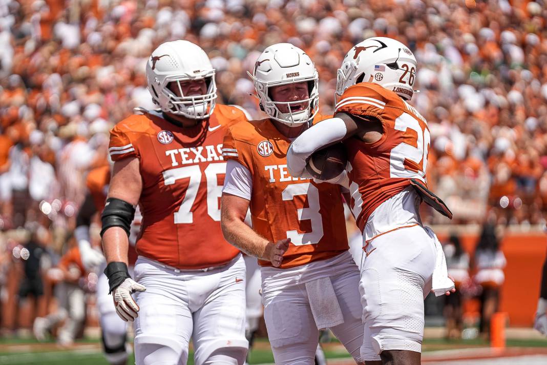 Texas Longhorns quarterback Quinn Ewers (3) and offensive lineman Hayden Conner (76) celebrate a touchdown by running back Quintrevion Wisner (26) during the game against Colorado State at Darrell K Royal-Texas Memorial Stadium in Austin on August 31, 2024.