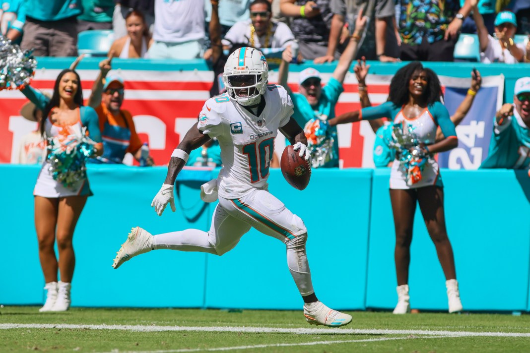 Miami Dolphins wide receiver Tyreek Hill (10) runs with the football for a touchdown against the Jacksonville Jaguars during the third quarter at Hard Rock Stadium on September 8, 2024.