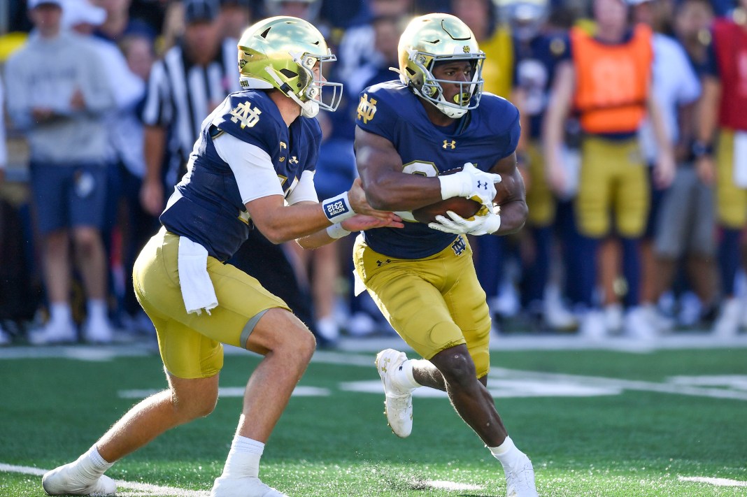 Notre Dame Fighting Irish quarterback Riley Leonard (13) hands off to running back Jadarian Price (24) in the third quarter against the Northern Illinois Huskies at Notre Dame Stadium on September 7, 2024.