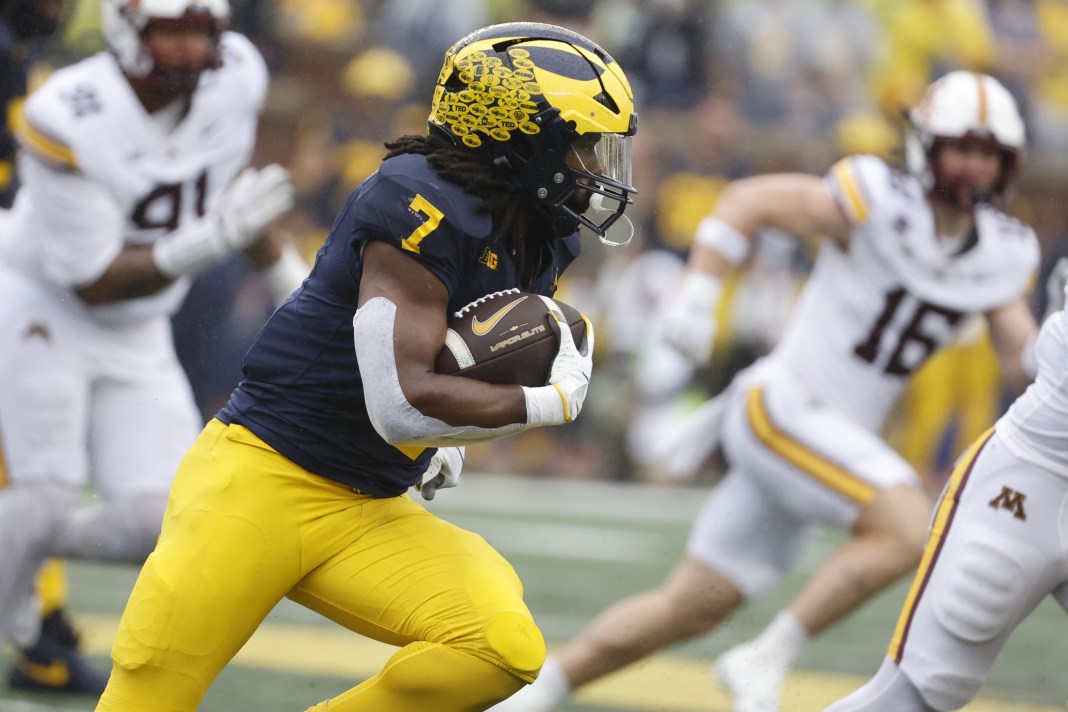 Michigan Wolverines running back Donovan Edwards (7) rushes with the ball during the first half against the Minnesota Golden Gophers at Michigan Stadium on September 28, 2024.