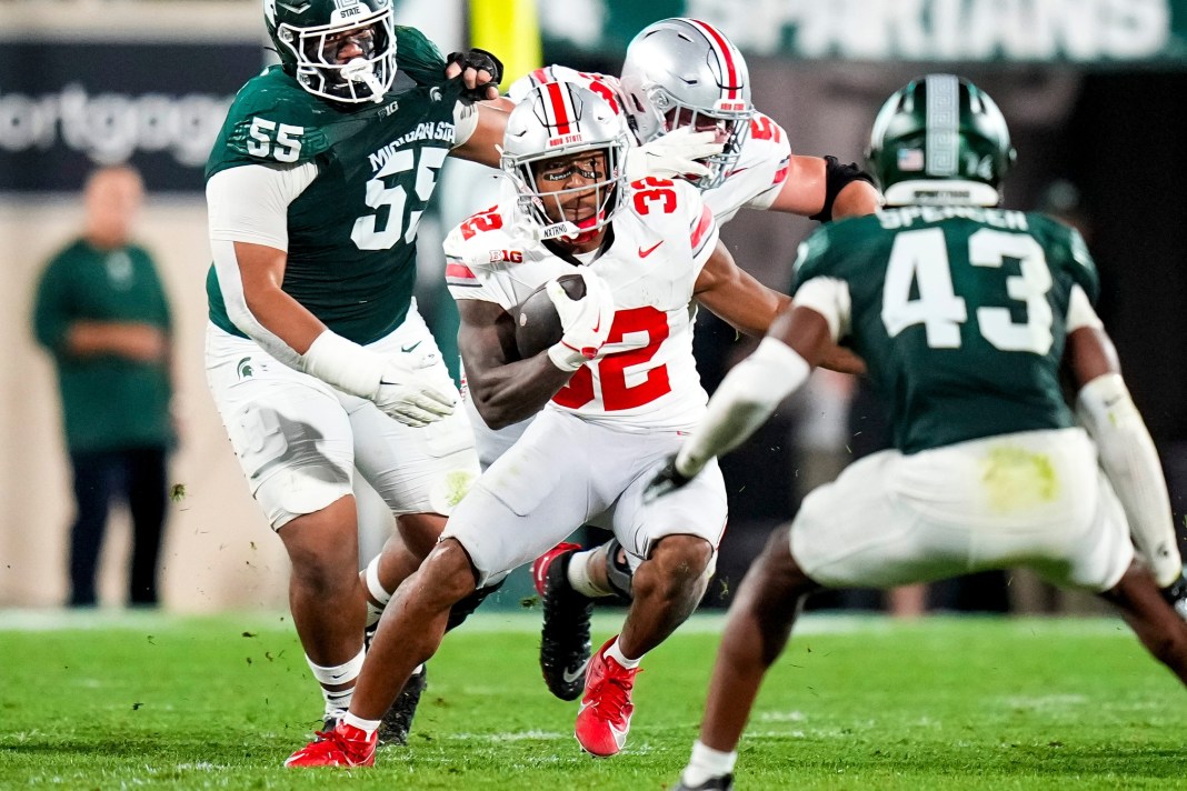 Syndication: The Columbus Dispatch Ohio State Buckeyes running back TreVeyon Henderson runs the ball against Michigan State Spartans defensive back Malik Spencer in the first half at Spartan Stadium on Saturday.