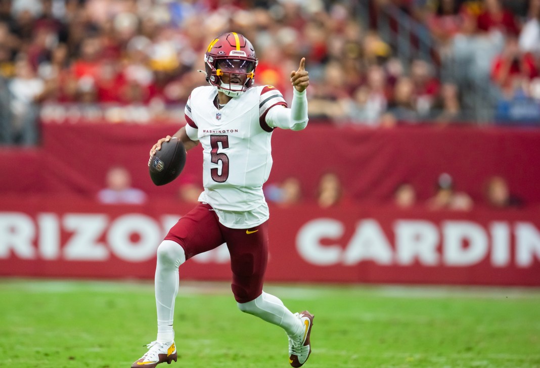 Washington Commanders quarterback Jayden Daniels (5) runs with the ball during the first half against the Arizona Cardinals at State Farm Stadium on September 29, 2024.