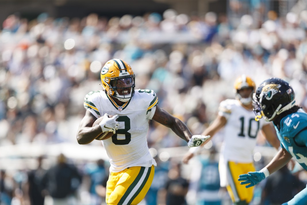 Green Bay Packers running back Josh Jacobs (8) runs the ball against the Jacksonville Jaguars during the second quarter at EverBank Stadium.