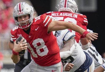 Ohio State Buckeyes quarterback Will Howard scrambles out of the pocket during the NCAA football game against the Akron Zips