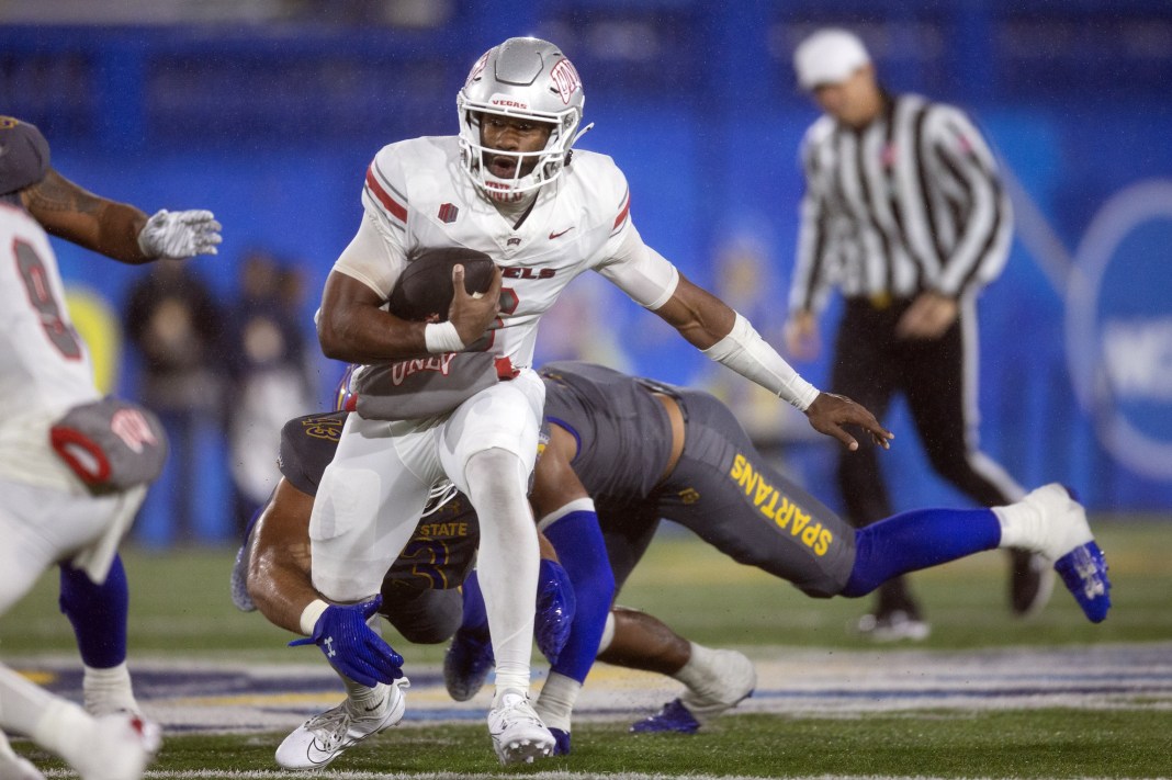 UNLV Rebels quarterback Hajj-Malik Williams (6) scrambles away from defensive pressure by the San Jose State Spartans