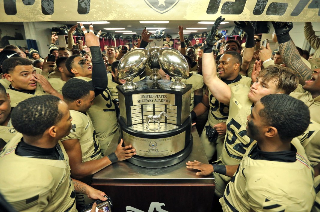 The Army Black Knights celebrate with the Commander-in-Chiefs trophy