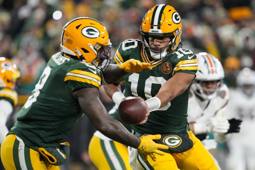 NFL: Miami Dolphins at Green Bay Packers Packers quarterback Jordan Love hands the ball off to running back Josh Jacobs during the 2024 NFL season.