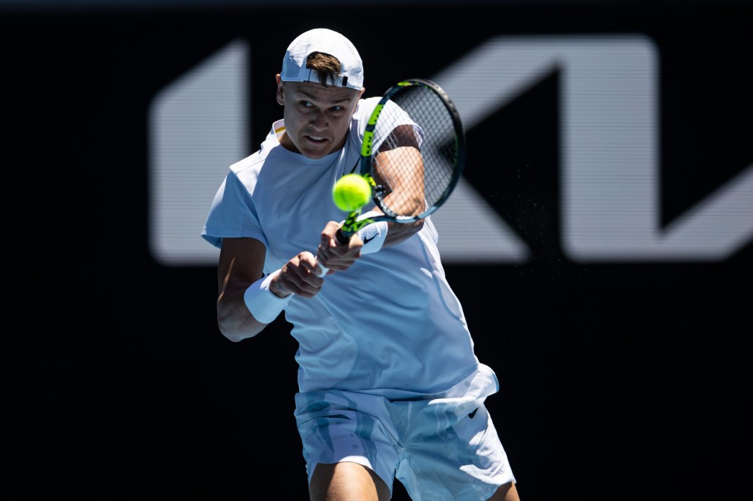 Tennis: Australian Open Holger Rune hits a backhand against Zhizhen Zhang at the 2025 Australian Open.