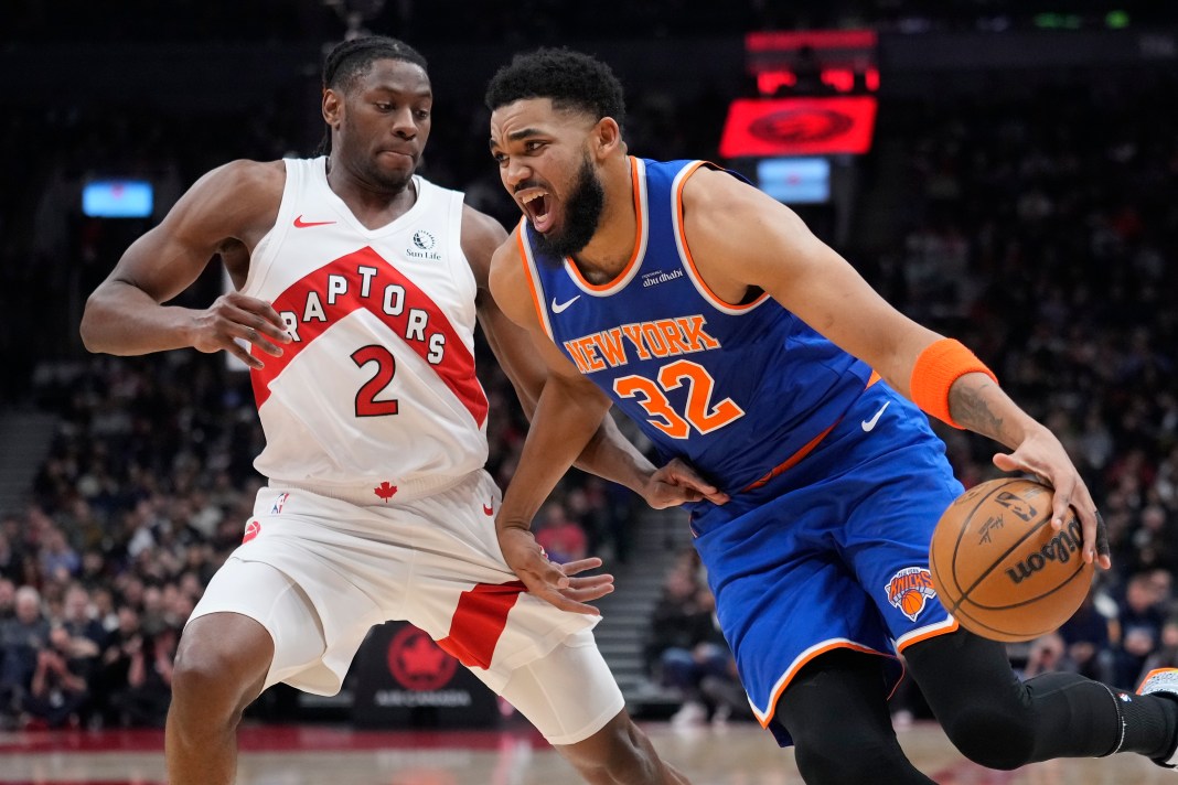 New York Knicks center Karl-Anthony Towns (32) drives to the net against Toronto Raptors forward Jonathon Mogbo (2) during the first half at Scotiabank Arena on February 4, 2025