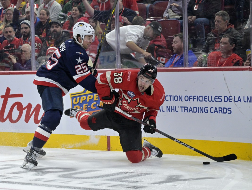 NHL: 4 Nations Face Off-USA vs Canada Team Canada forward Brandon Hagel (38) plays the puck while Team United States defenseman Charlie McAvoy (25) defends during the second period of a 4 Nations Face-Off ice hockey game at the Bell Centre on February 15, 2025.