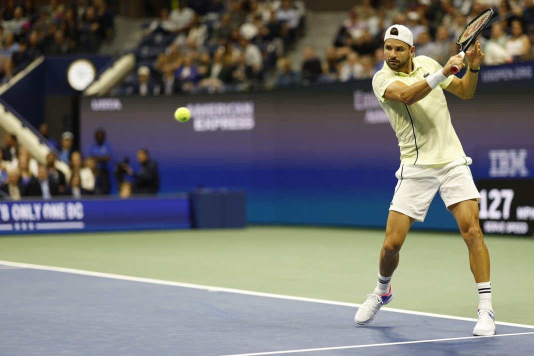 Grigor Dimitrov hits a backhand against Frances Tiafoe at the 2024 US Open.