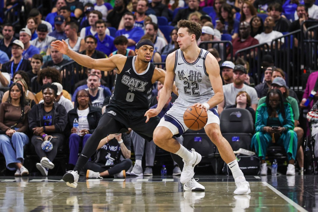 Magic forward Franz Wagner backs down Keldon Johnson in a meeting with the Spurs during the 2024-25 NBA season.