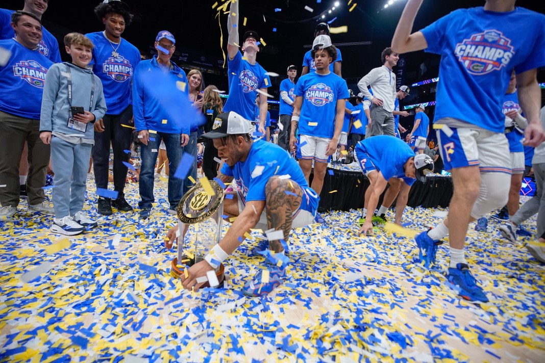Florida guard Alijah Martin (15) holds the SEC trophy as the team celebrates their win over Tennessee after the Southeastern Conference tournament championship at Bridgestone Arena in Nashville, Tenn., on Sunday, March 16, 2025.