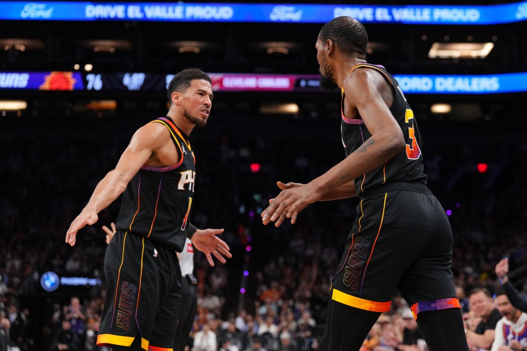 Suns stars Devin Booker and Kevin Durant celebrate a win over the Cavaliers during the 2024-25 NBA season.