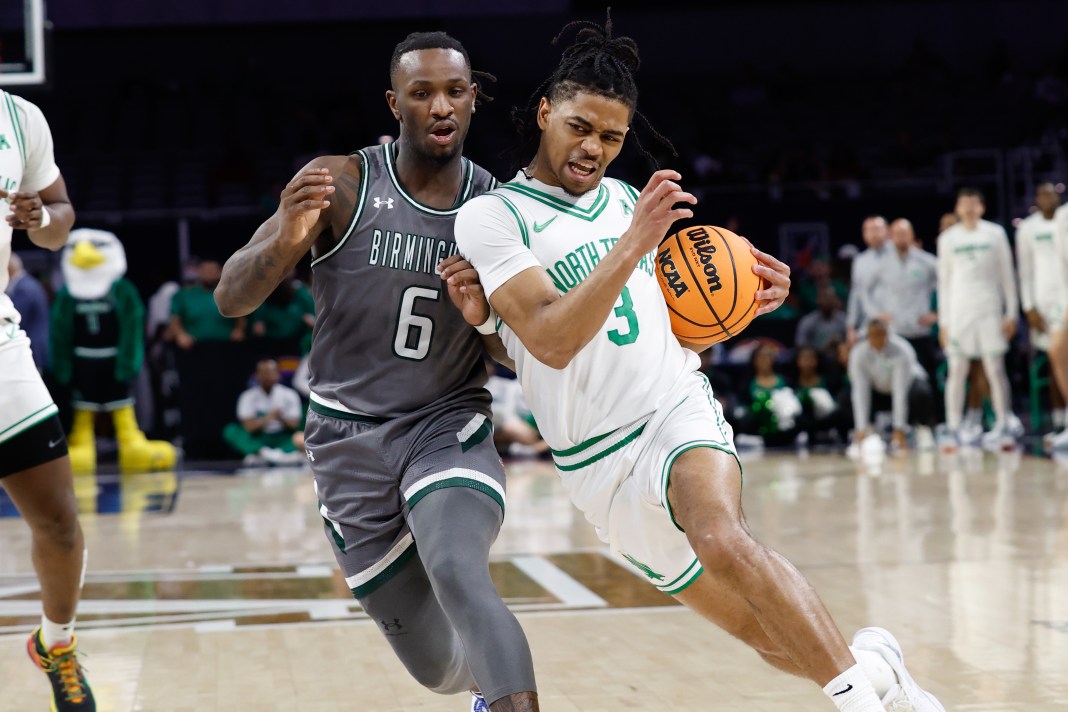 North Texas Mean Green guard Jasper Floyd (3) drives to the basket while UAB Blazers guard Tony Toney (6) defends during the first half at Dickies Arena in Fort Worth, TX, on March 15, 2025.