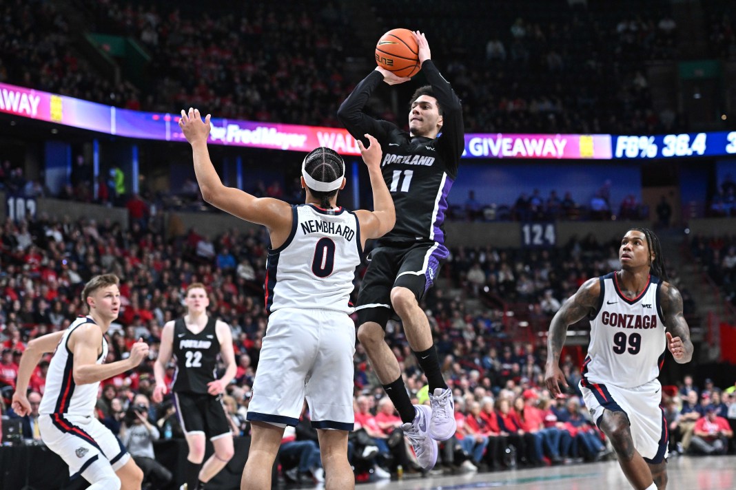 Portland Pilots guard Vincent Delano (11) shoots over Gonzaga Bulldogs guard Ryan Nembhard (0) during the first half at Spokane Veterans Memorial Arena on January 2, 2025.