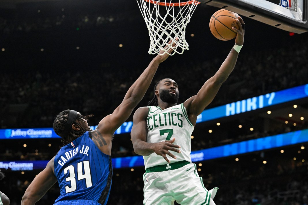 Boston Celtics guard Jaylen Brown (7) shoots a layup over Orlando Magic center Wendell Carter Jr. (34) during the second half of the game at TD Garden in Boston, Massachusetts, on January 17, 2025.