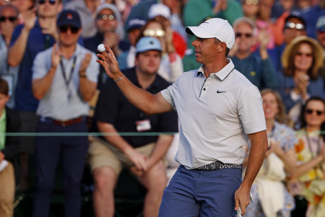 Rory McIlroy waves to the patrons after his putt on the 18th green during the third round of the Masters Tournament at Augusta National Golf Club in Augusta, Georgia, on April 12, 2025.