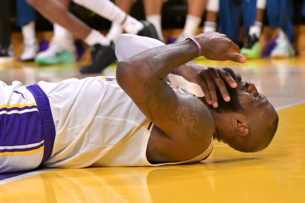 Los Angeles Lakers forward LeBron James (23) reacts after taking an elbow from Minnesota Timberwolves forward Julius Randle (30) in the second half at Crypto.com Arena in Los Angeles, California, on April 19, 2025.