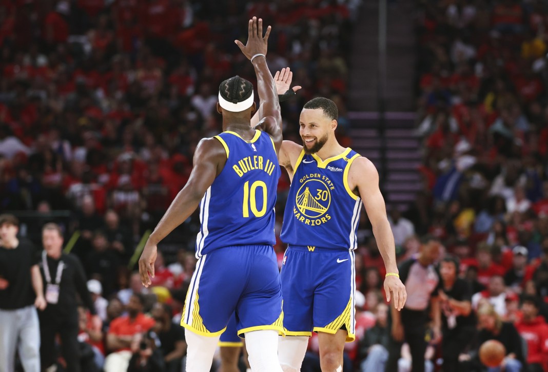 NBA: Playoffs-Golden State Warriors at Houston Rockets Warriors stars Stephen Curry and Jimmy Butler high five during a game against the Rockets in the 2024-25 NBA Playoffs.