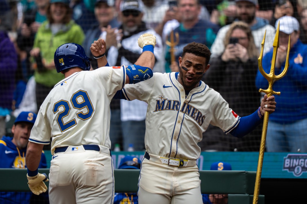 Seattle Mariners catcher Cal Raleigh (29) is congratulated by centerfielder Julio Rodriguez (44) after hitting a solo home run during the first inning of the game against the Miami Marlins at Lumen Field in Seattle, Washington, on April 27, 2025.