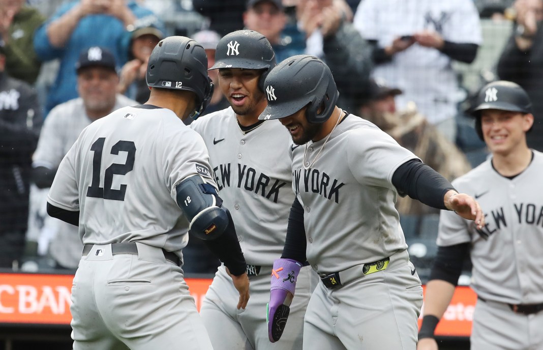 New York Yankees center fielder Trent Grisham (12) celebrates his second home run of the game with third baseman Oswald Peraza (middle) and left fielder Jasson Dominguez (right) during the fifth inning against the Pittsburgh Pirates at PNC Park in Pittsburgh, Pennsylvania, on April 5, 2025.