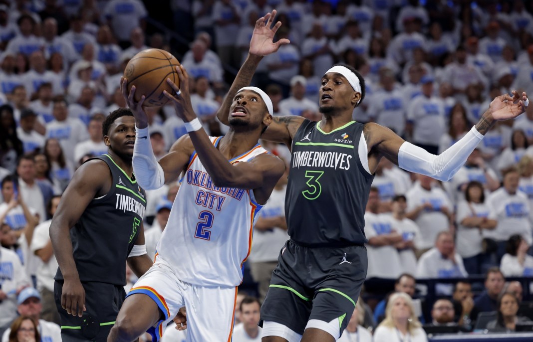 Oklahoma City, Oklahoma, USA; Oklahoma City Thunder guard Shai Gilgeous-Alexander (2) drives against Minnesota Timberwolves forward Jaden McDaniels (3) i