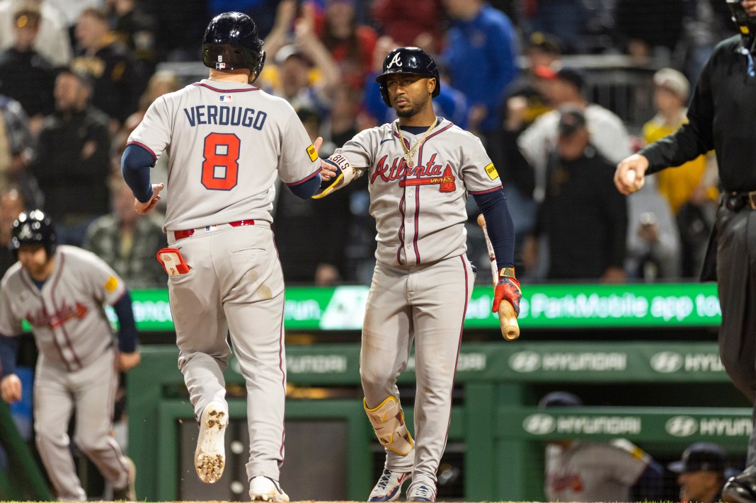 Atlanta Braves second baseman Ozzie Albies (1) slaps hands to congratulate outfielder Alex Verdugo (8) on his score during the ninth inning of the game against the Pittsburgh Pirates at PNC Park in Pittsburgh, Pennsylvania, on May 9, 2025.