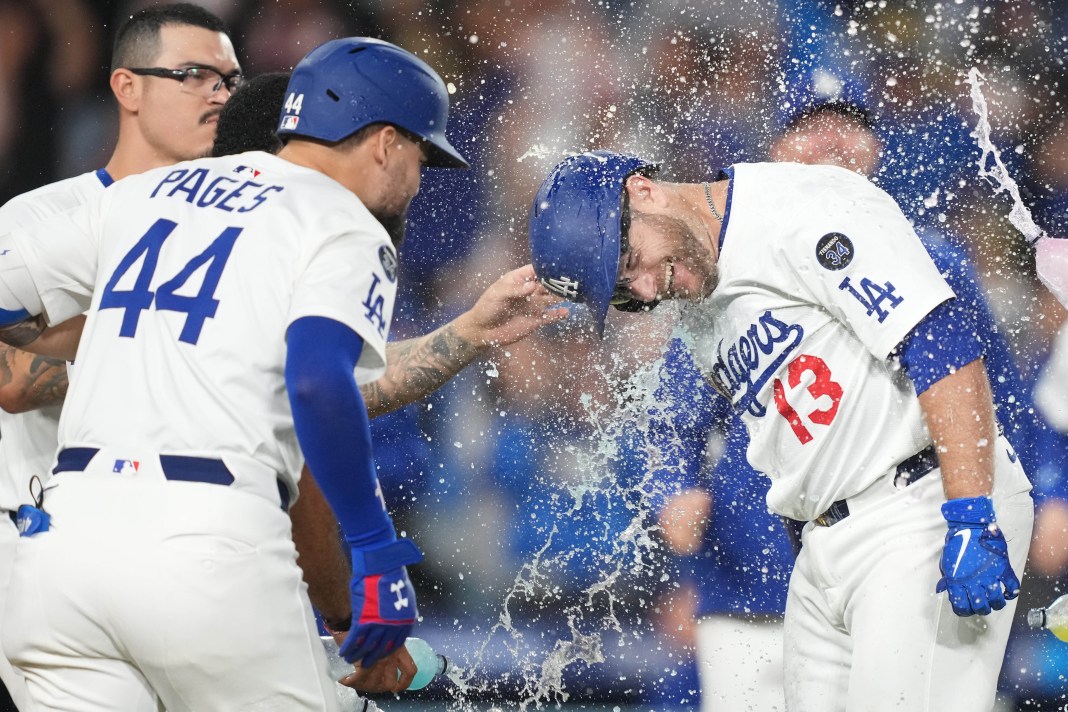 Los Angeles Dodgers third baseman Max Muncy (13) celebrates with right fielder Andy Pages (44) after hitting a sacrifice fly in the 10th inning of the game against the Arizona Diamondbacks at Dodger Stadium in Los Angeles, California, on May 20, 2025.
