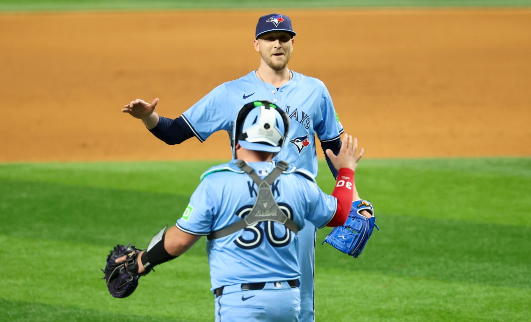 Toronto Blue Jays relief pitcher Jeff Hoffman (23) celebrates with catcher Alejandro Kirk (30) after the game against the Texas Rangers at Globe Life Field in Arlington, Texas, on May 28, 2025.