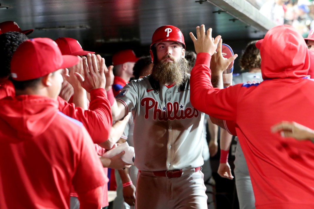 Philadelphia Phillies' Brandon Marsh (16) is congratulated by teammates after scoring a run on a hit by Bryce Harper (not pictured) during the seventh inning of the game against the Athletics at Sutter Health Park in West Sacramento, California, on May 24, 2025.
