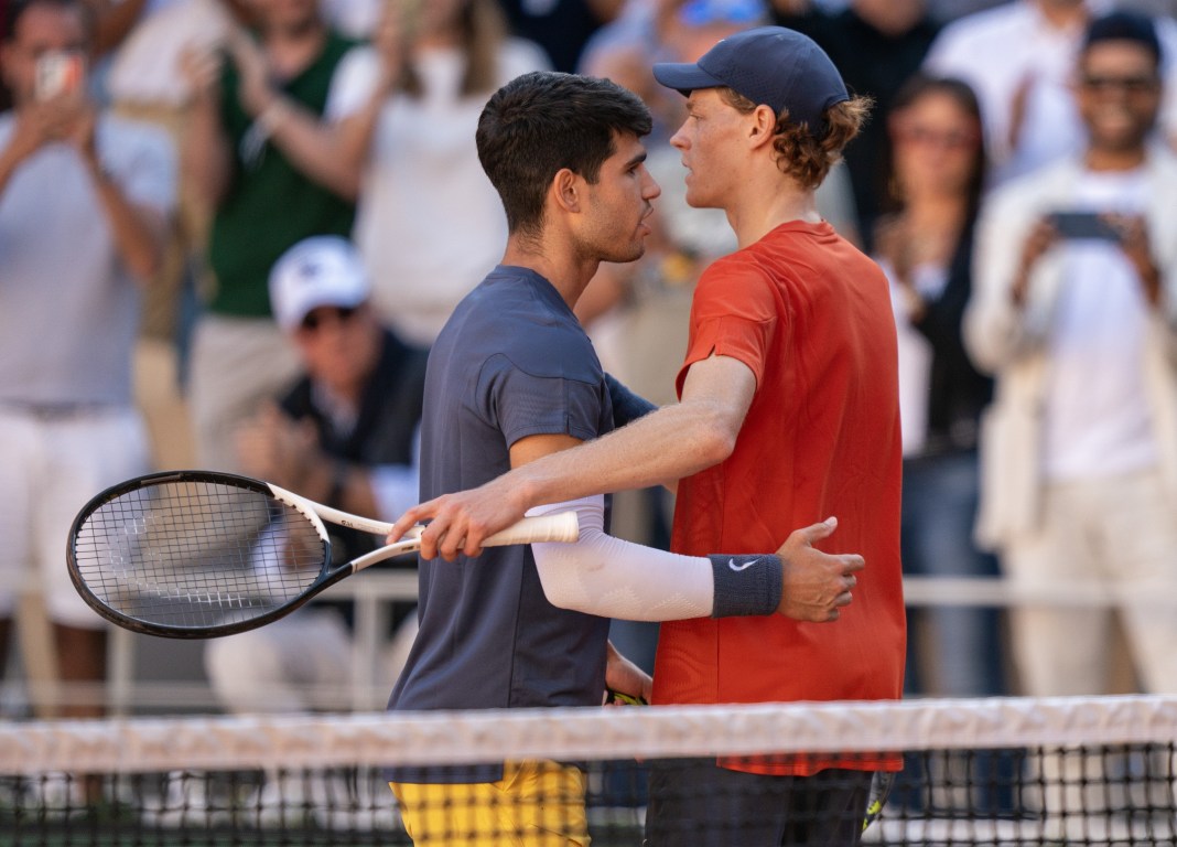 Carlos Alcaraz and Jannik Sinner meet at the net at the 2024 French Open in Roland Garros.