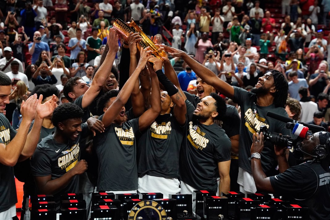 Miami Heat players lift the 2025 Summer League Champions trophy after defeating the Memphis Grizzlies in overtime at Thomas & Mack Center on July 22, 2024.