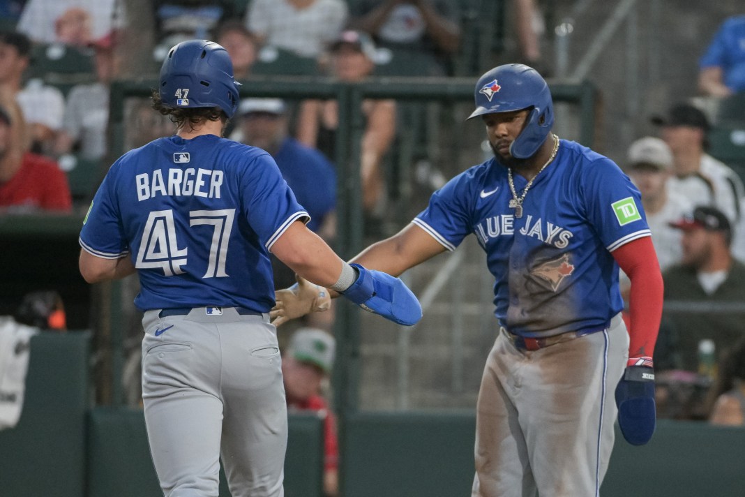 Toronto Blue Jays third baseman Addison Barger (47) celebrates with first baseman Vladimir Guerrero Jr. (27) after scoring against the Athletics during the fifth inning at Sutter Health Park in West Sacramento, California, on July 11, 2025.