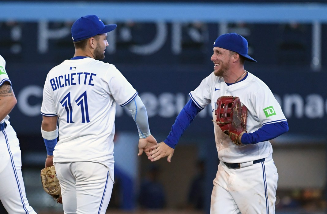 Toronto Blue Jays shortstop Bo Bichette (11) and center fielder Myles Straw (3) celebrate after a win over the Los Angeles Angels at Rogers Centre on July 6, 2025.