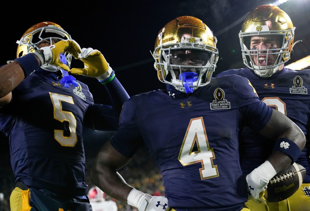Notre Dame star Jeremiyah Love poses with teammates after scoring against Indiana during the 2024 college football season.