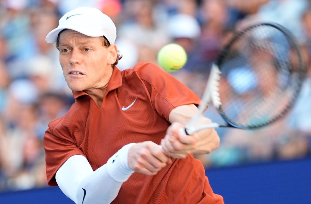 Jannik Sinner hits a backhand against Denis Shapovalov at the 2025 US Open.